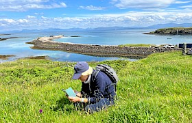Guest checking out the orchids on the Isle of Eigg by Guide Lynsey Bland